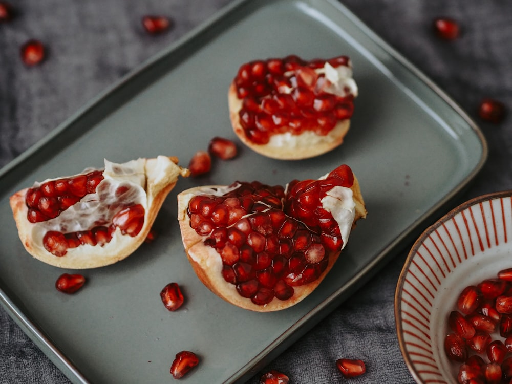 a couple of pomegranates sitting on top of a plate