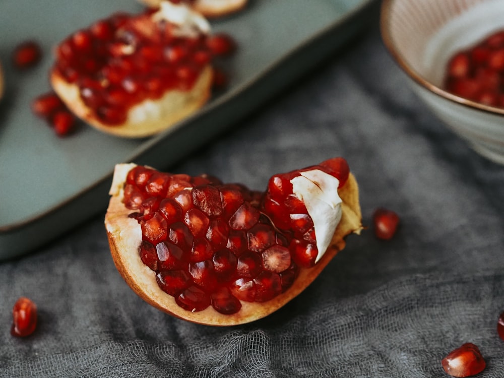 a pomegranate is cut in half on a plate