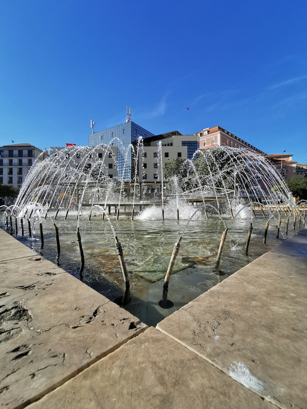 a water fountain in the middle of a city