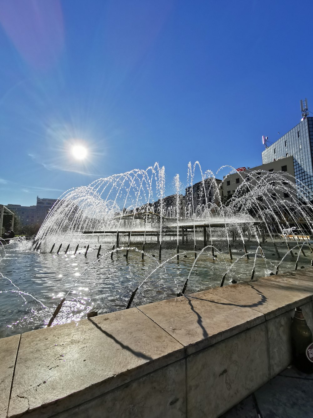 a water fountain in the middle of a body of water