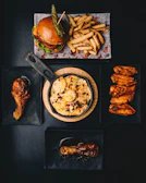 a table topped with plates of food and a burger