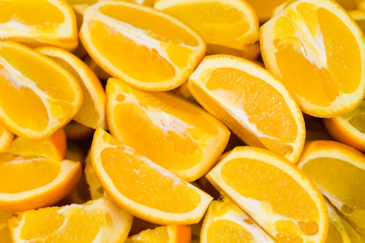 A collection of fresh, juicy orange slices arranged closely together, showcasing their vibrant color and texture.