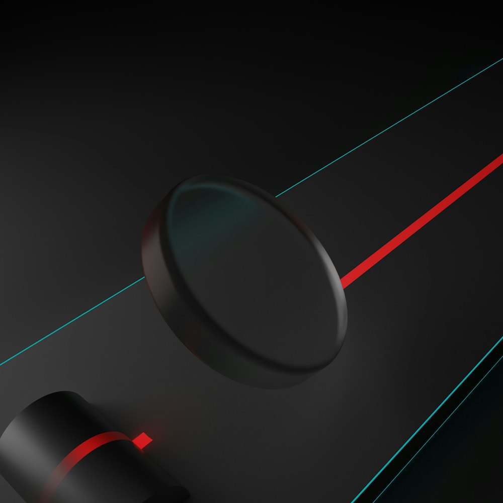 a close up of a black object with red lines