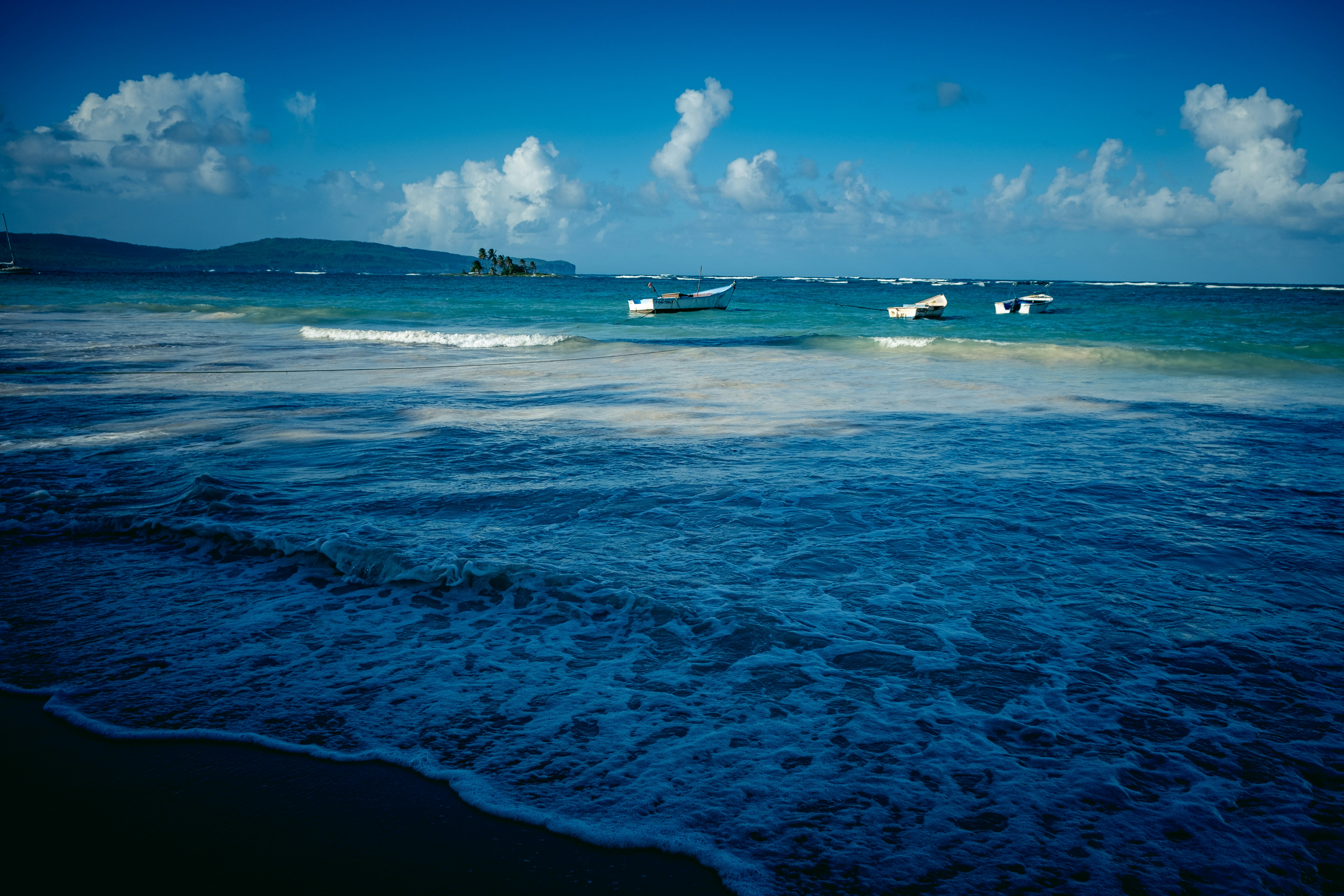a group of boats floating on top of a body of water