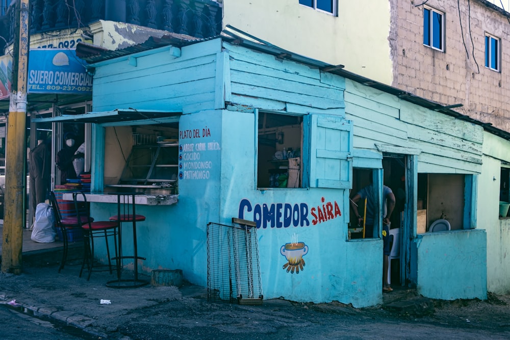 a blue building with a sign on the side of it