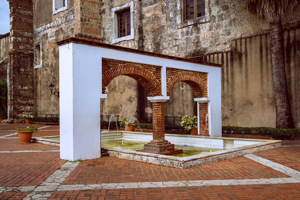 a brick building with a fountain in front of it