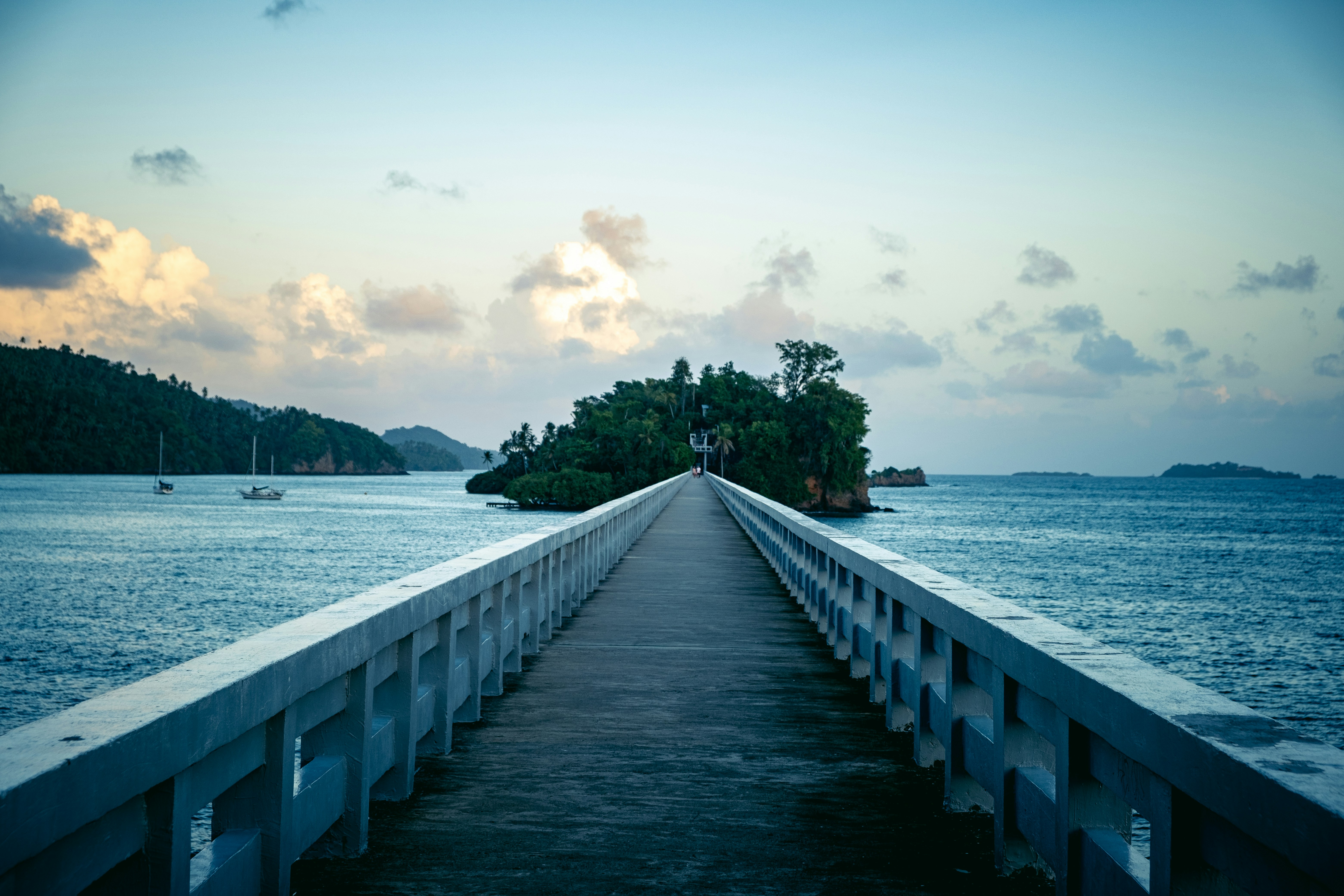 a long pier stretches out into the ocean