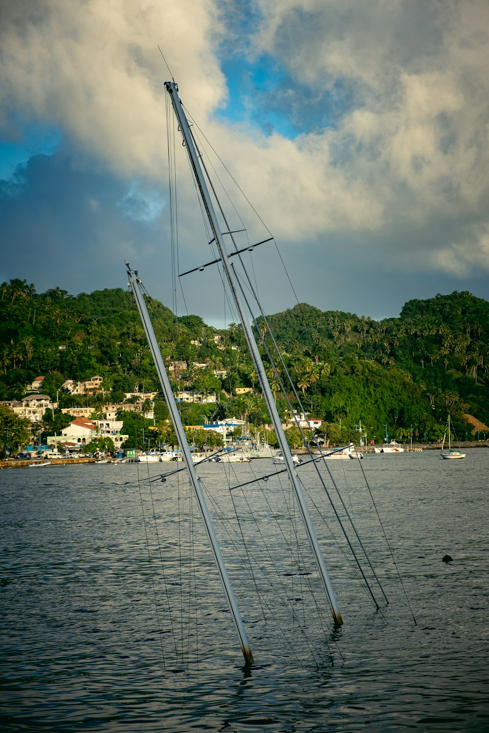 a sailboat in a body of water with a mountain in the background