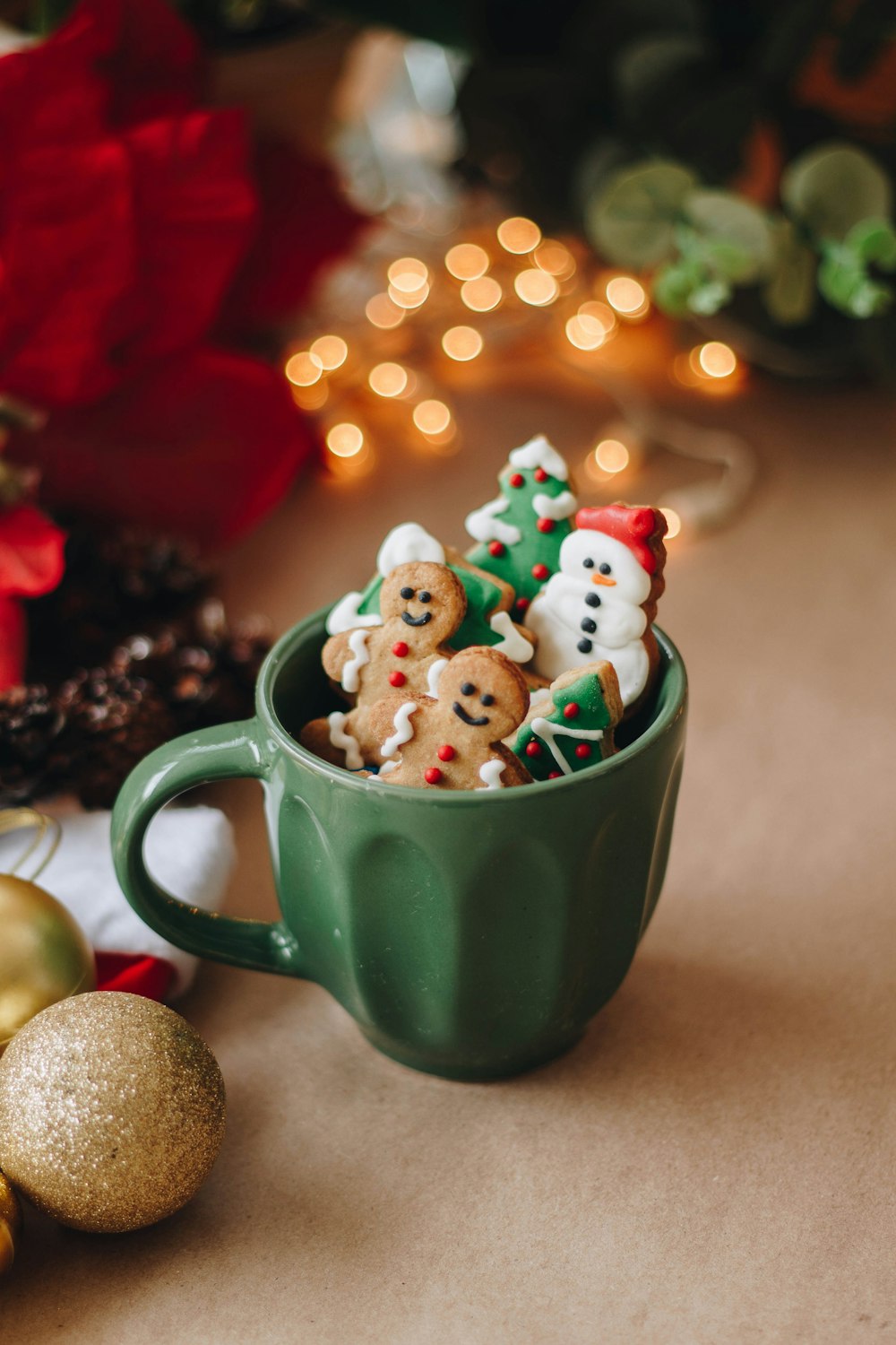 a cup filled with christmas cookies on top of a table