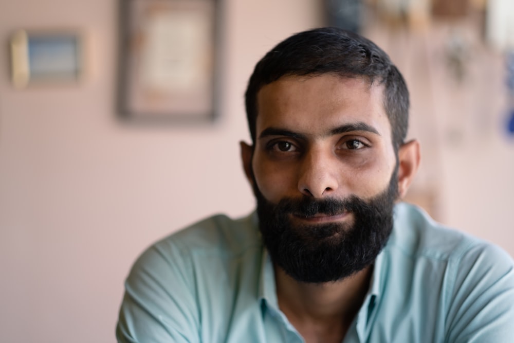 a man with a beard and a blue shirt