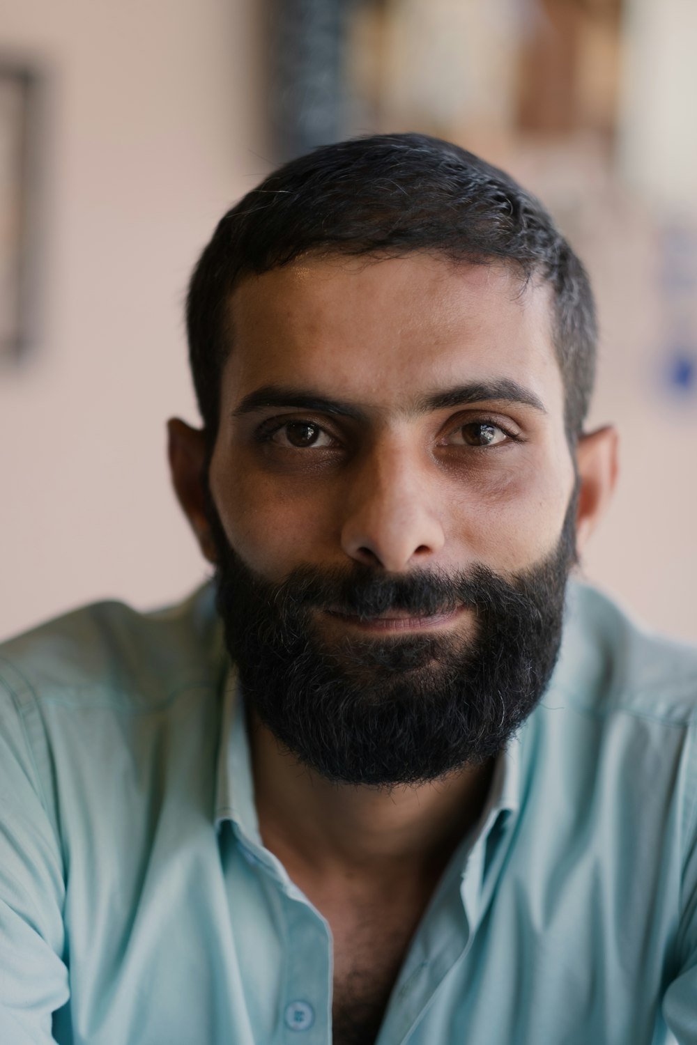 a man with a beard and a blue shirt