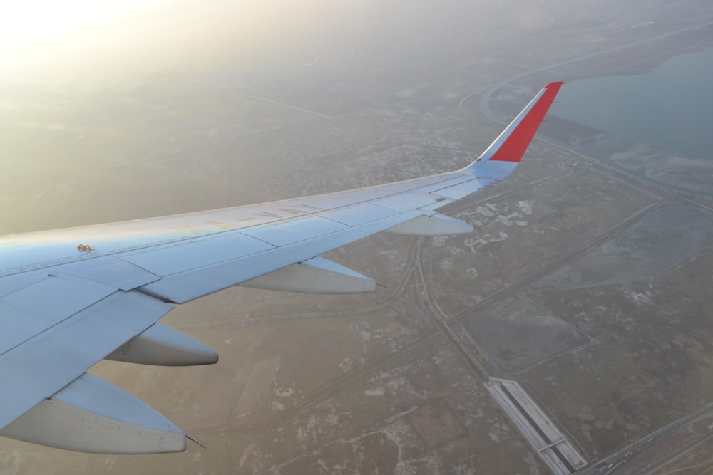 the wing of an airplane flying over a city