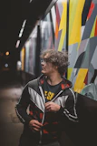 a man standing in front of a colorful wall