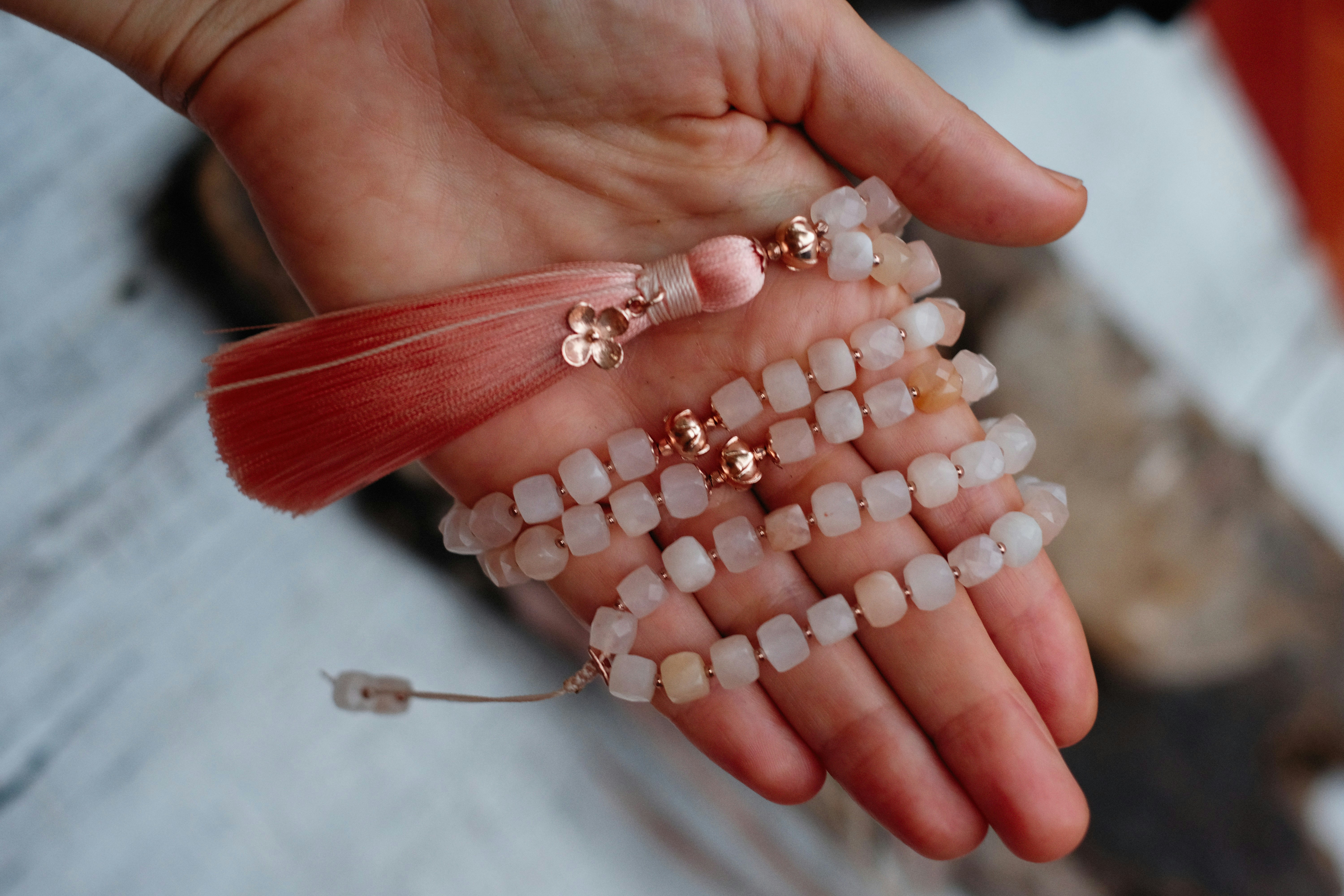 a person holding a bunch of beads in their hands