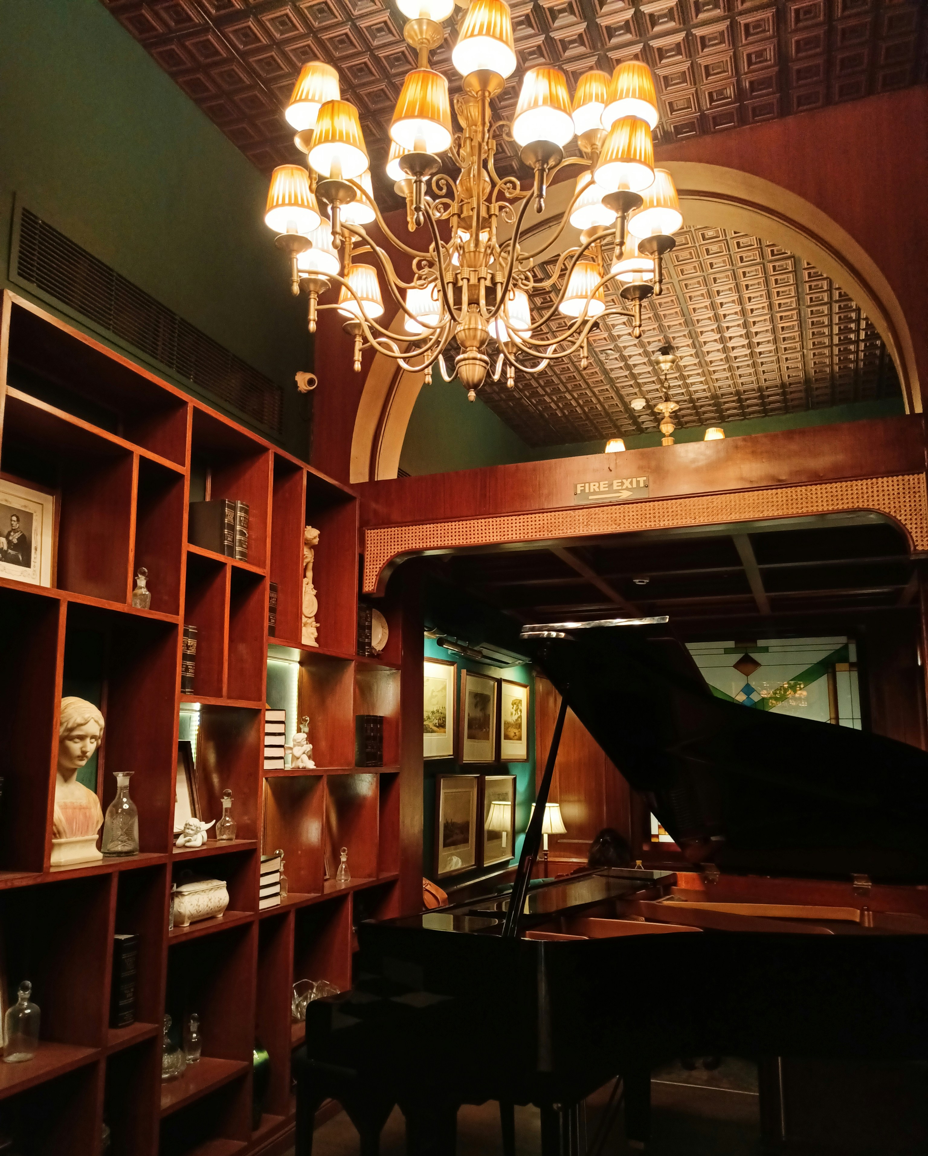 a grand piano in a room with a chandelier