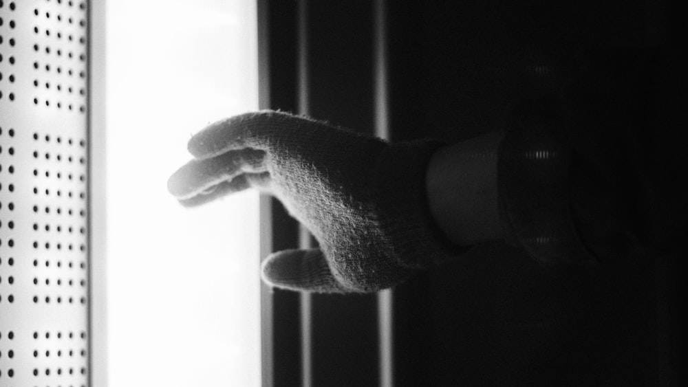 a person's hand holding onto a door handle