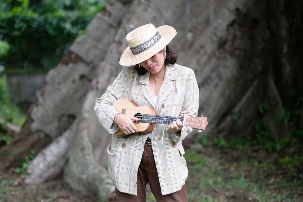 a woman with a hat playing a guitar