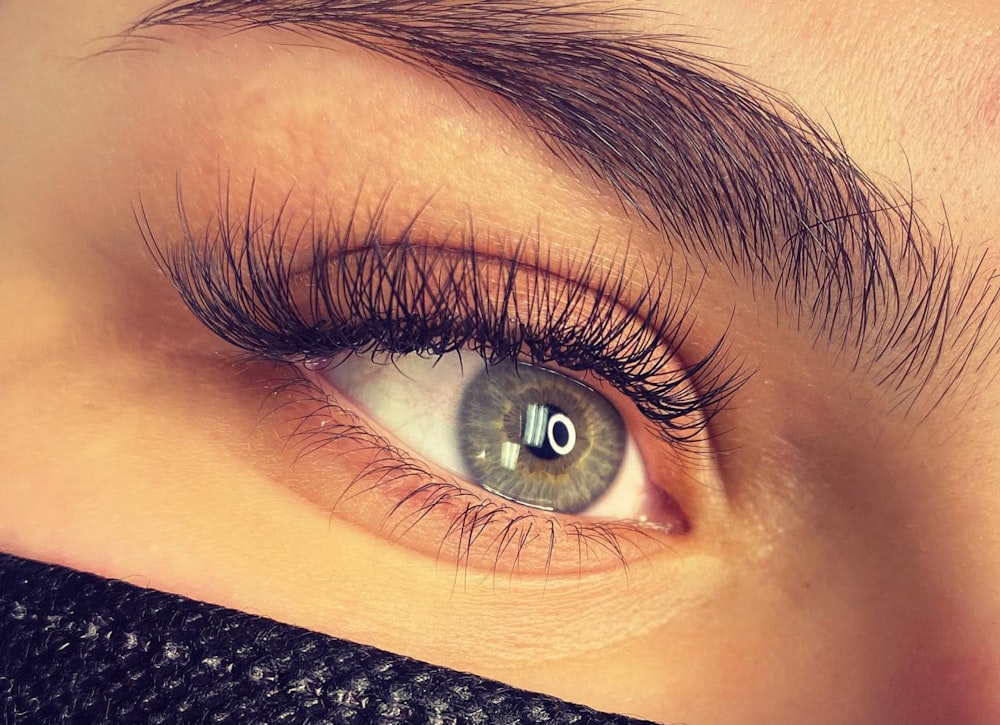 a close up of a person's eye with long lashes