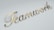 The word 'Teamwork' is written in elegant, gold cursive lettering against a light gray background.