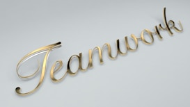 The word 'Teamwork' is written in elegant, gold cursive lettering against a light gray background.