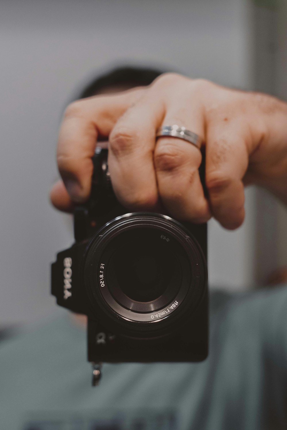 a man holding a camera up to take a picture