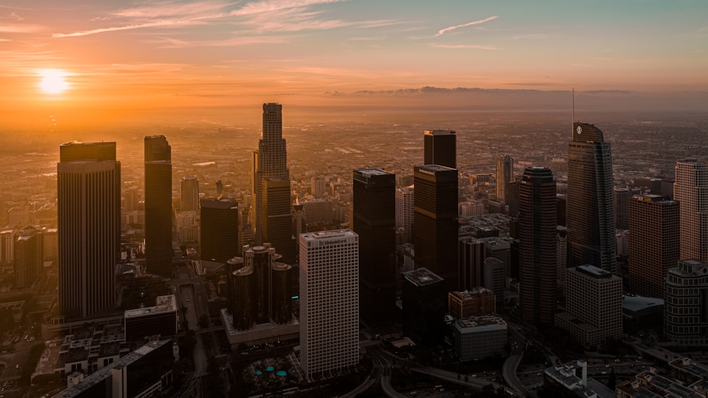 the sun is setting over a large city