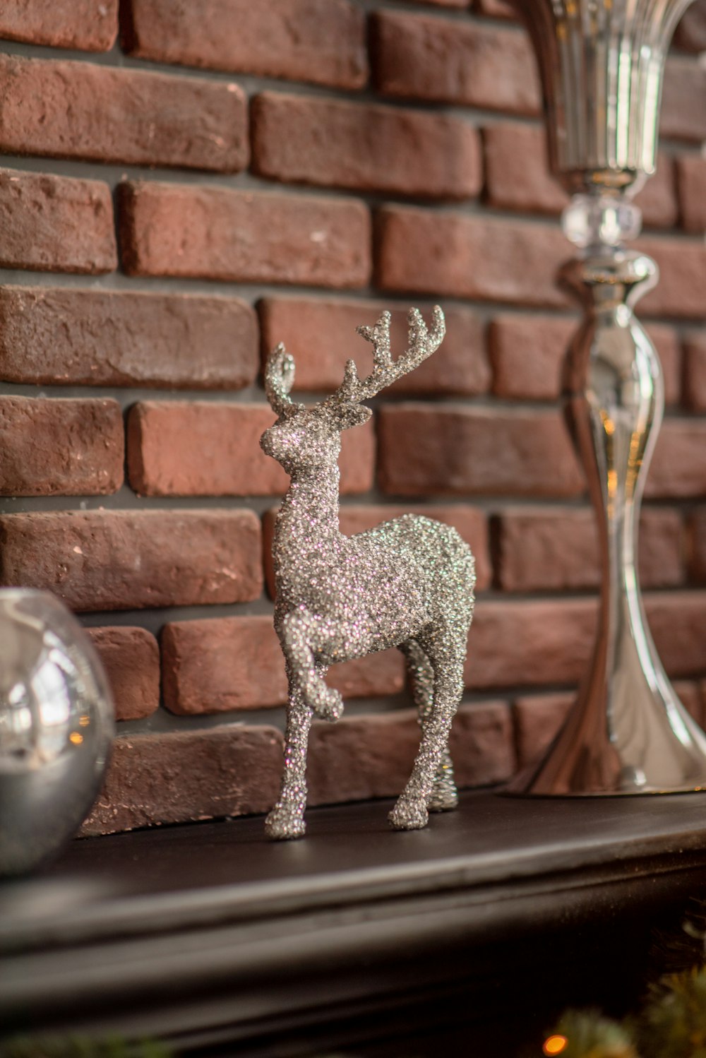 a silver deer figurine sitting on top of a mantle
