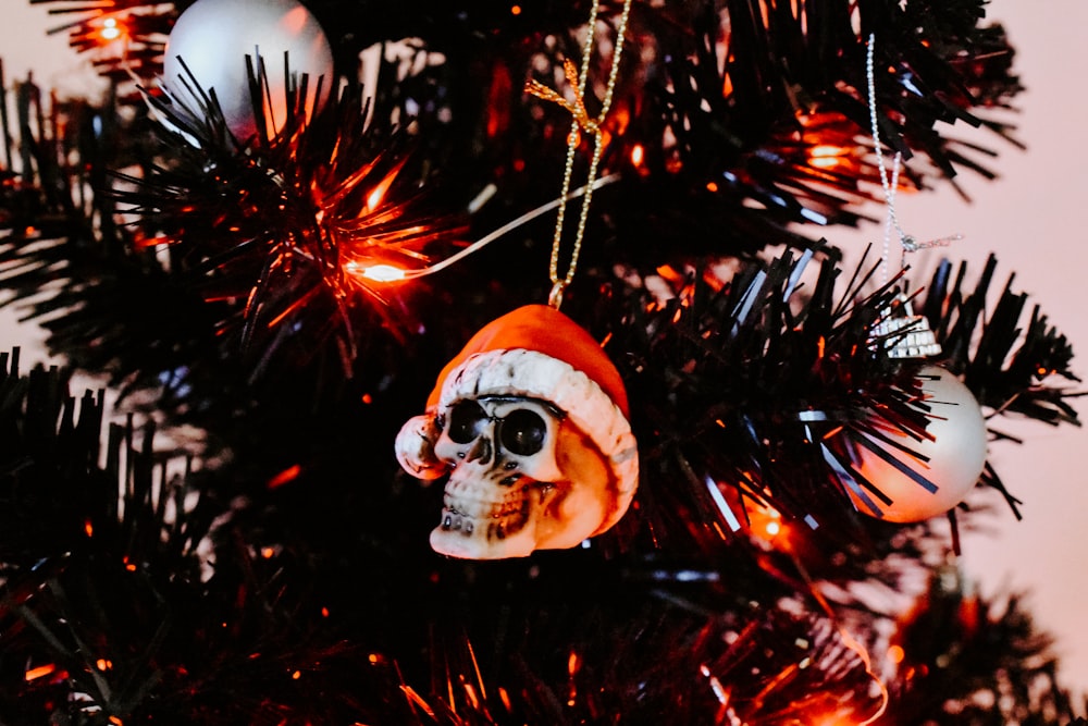 a skull ornament hanging from a christmas tree