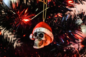 a skull ornament hanging from a christmas tree