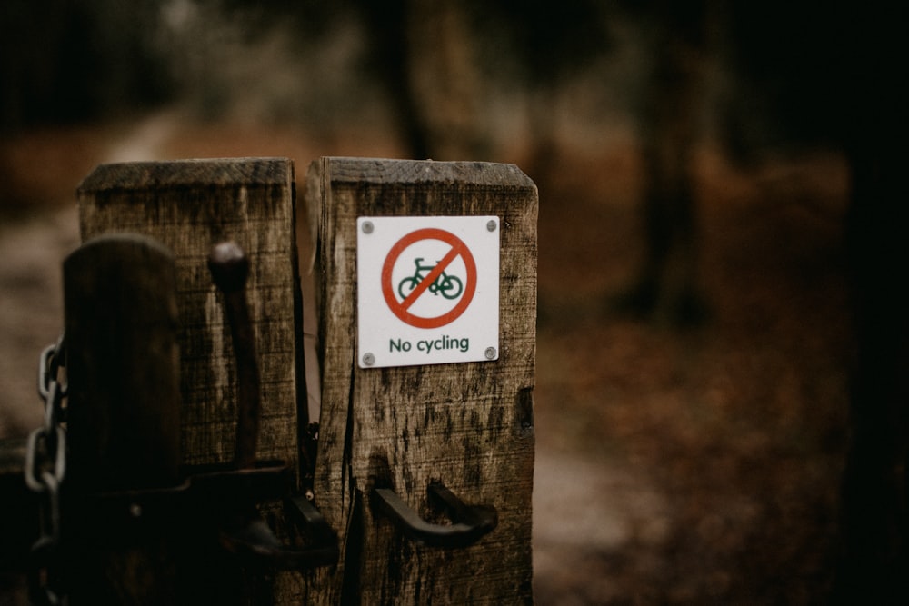 a wooden post with a no bicycle sign on it