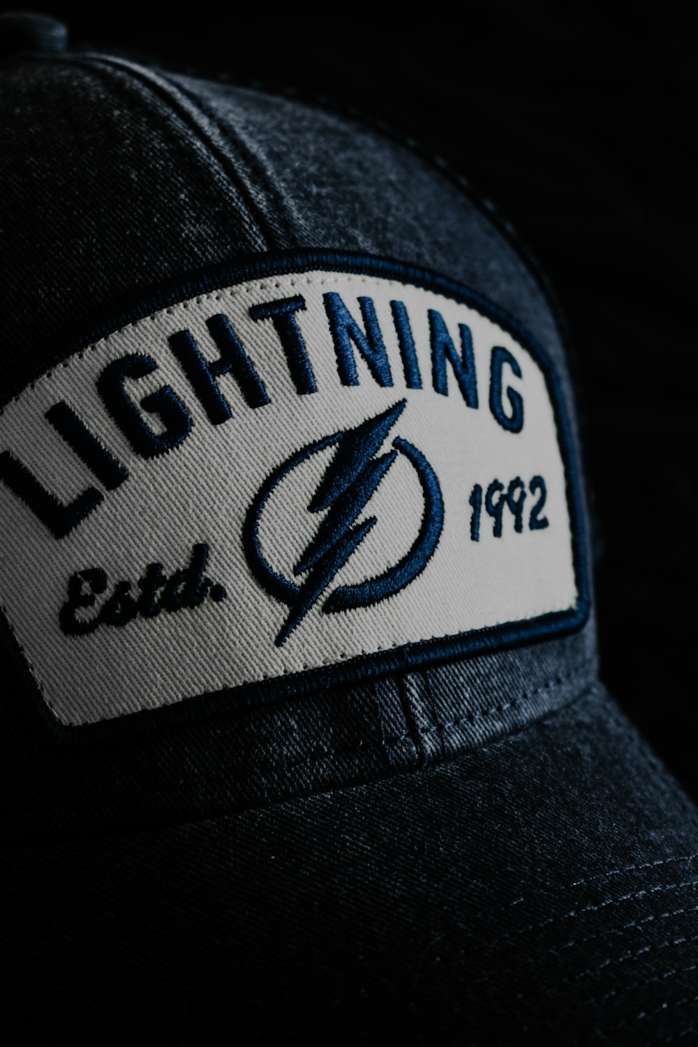 a hat with a lightning patch on it