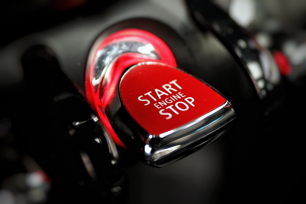 a close up of a red stop button on a car