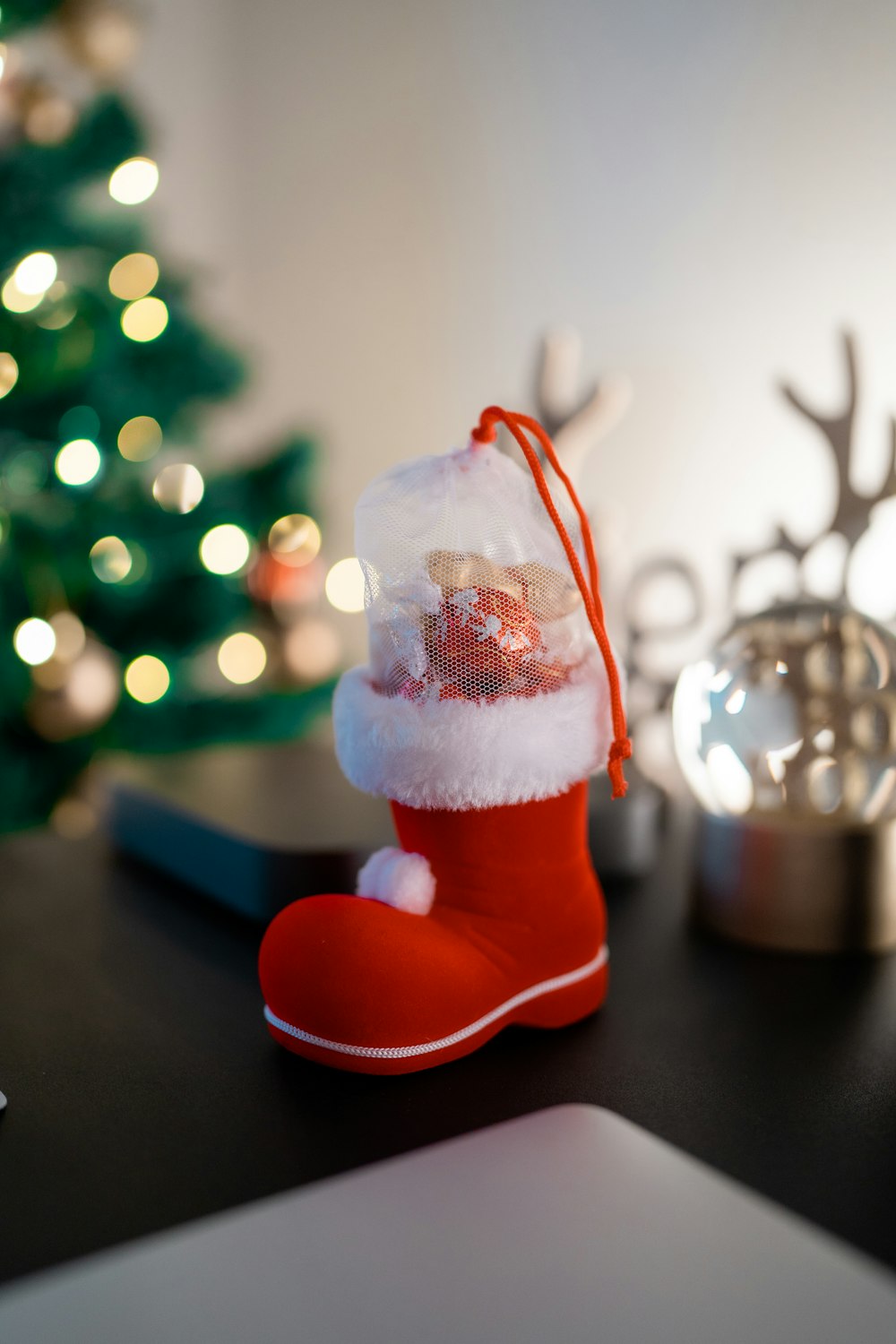 a christmas stocking sitting on top of a table next to a laptop