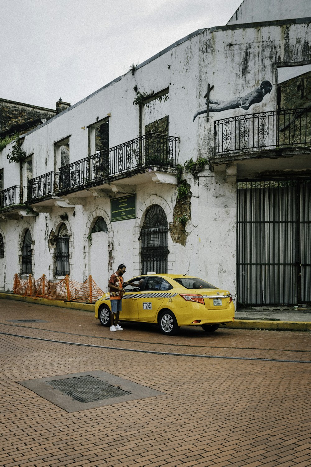 a yellow car parked in front of a white building