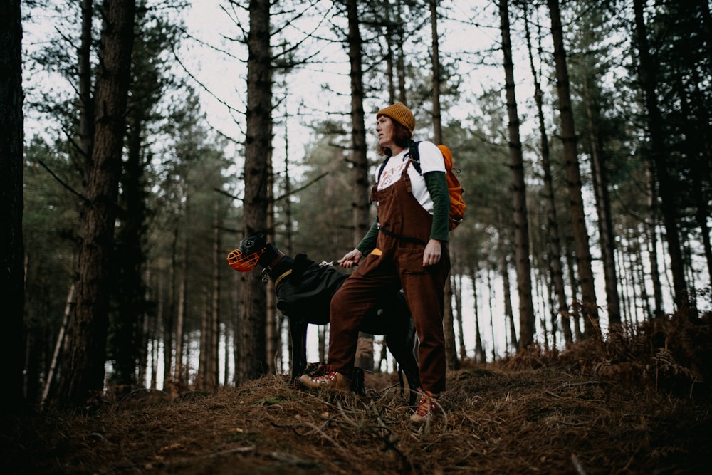 a man with a dog in the woods