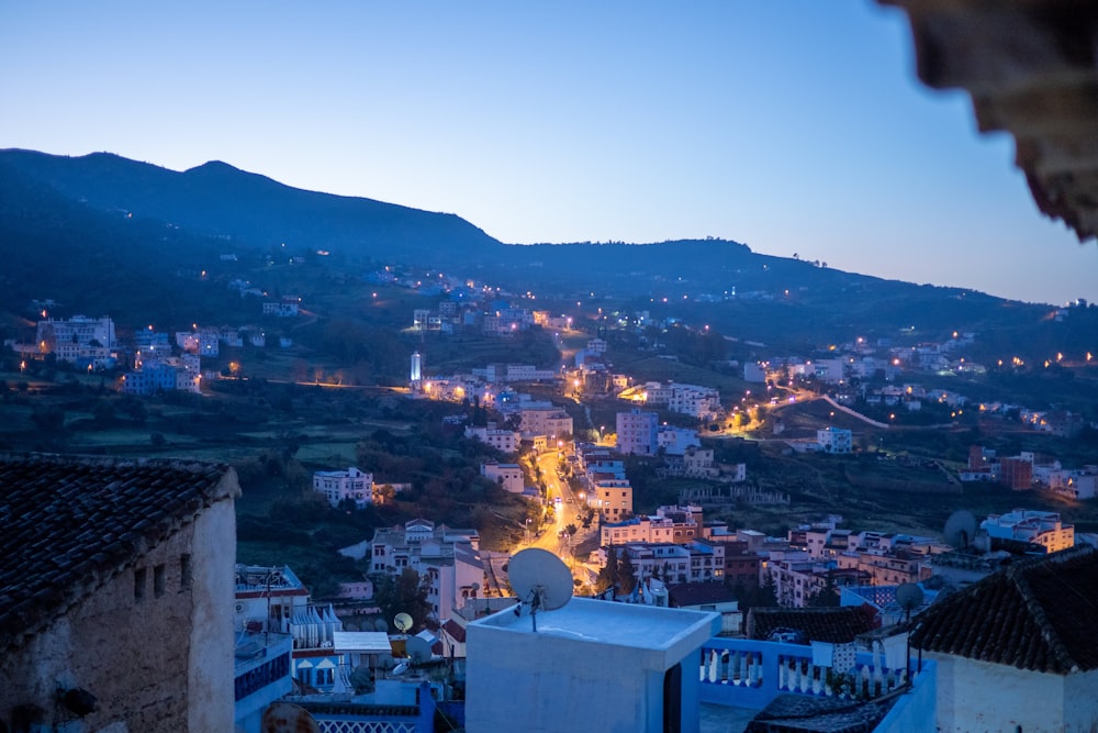 a view of a city at night from a hill