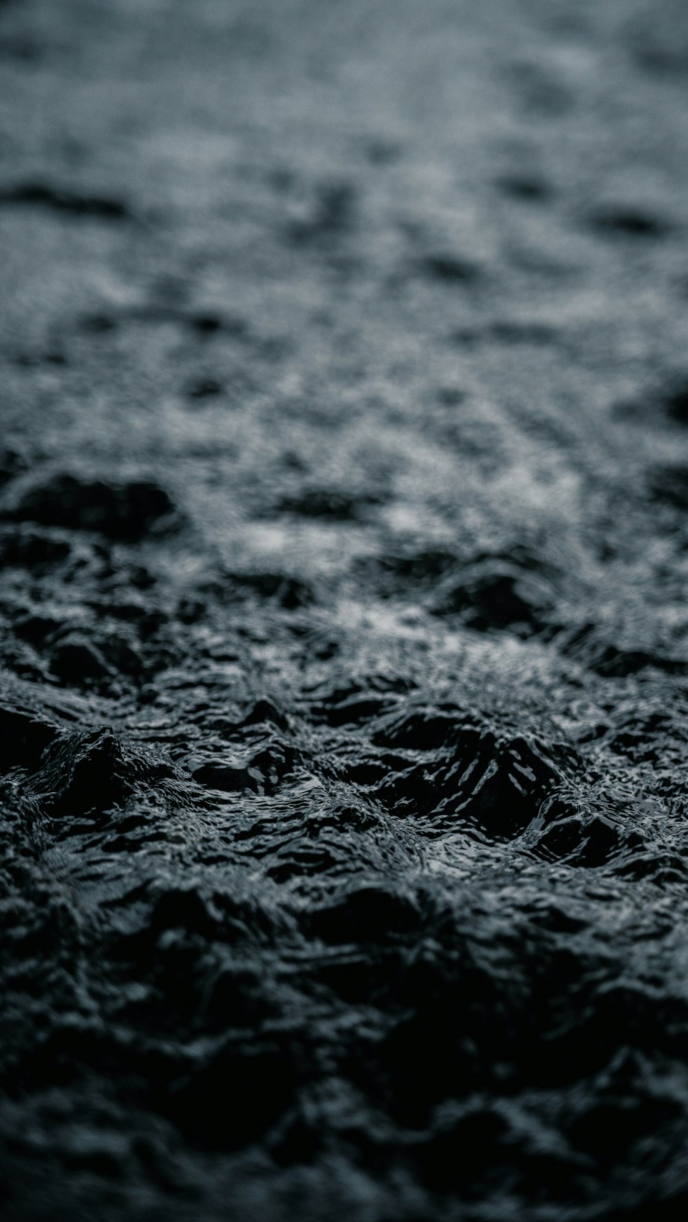 a black and white photo of water and rocks