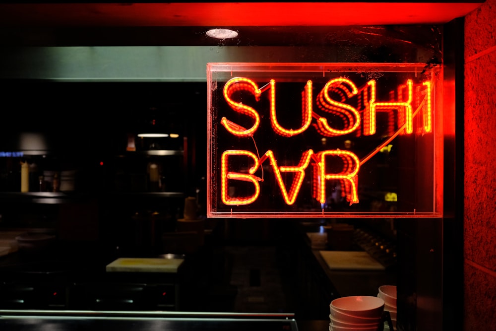 a neon sign that reads sushi bar