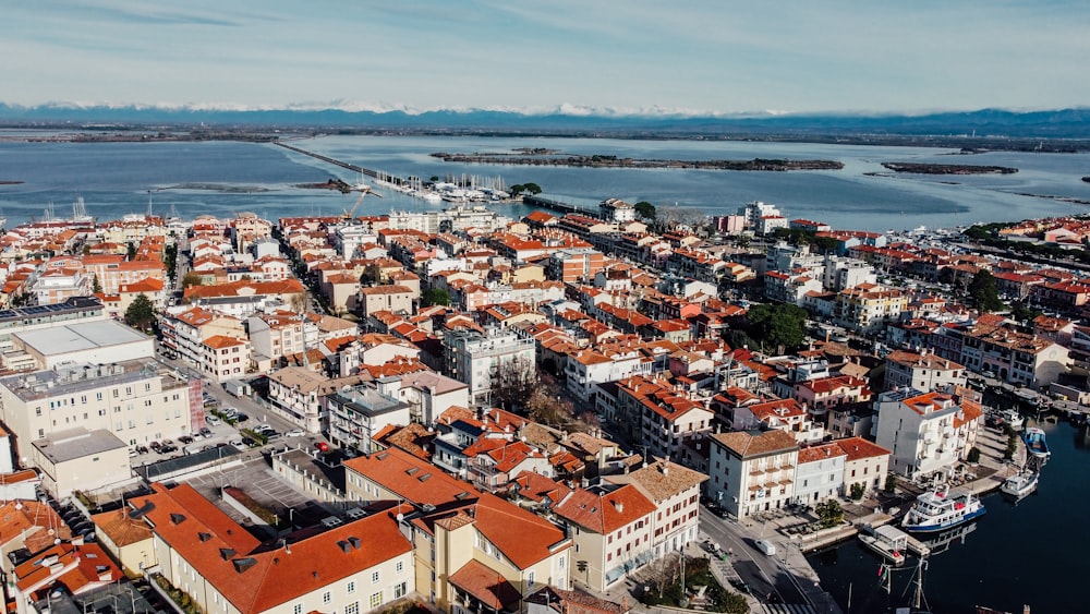 an aerial view of a city next to a body of water