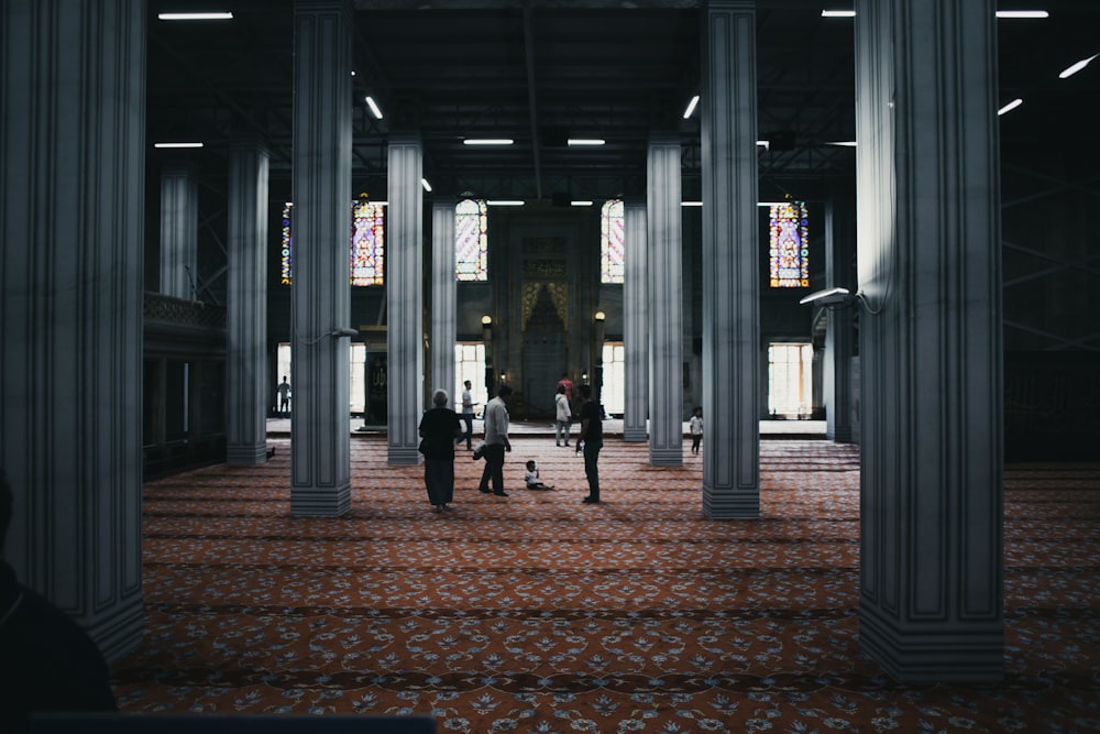 a group of people walking through a large building