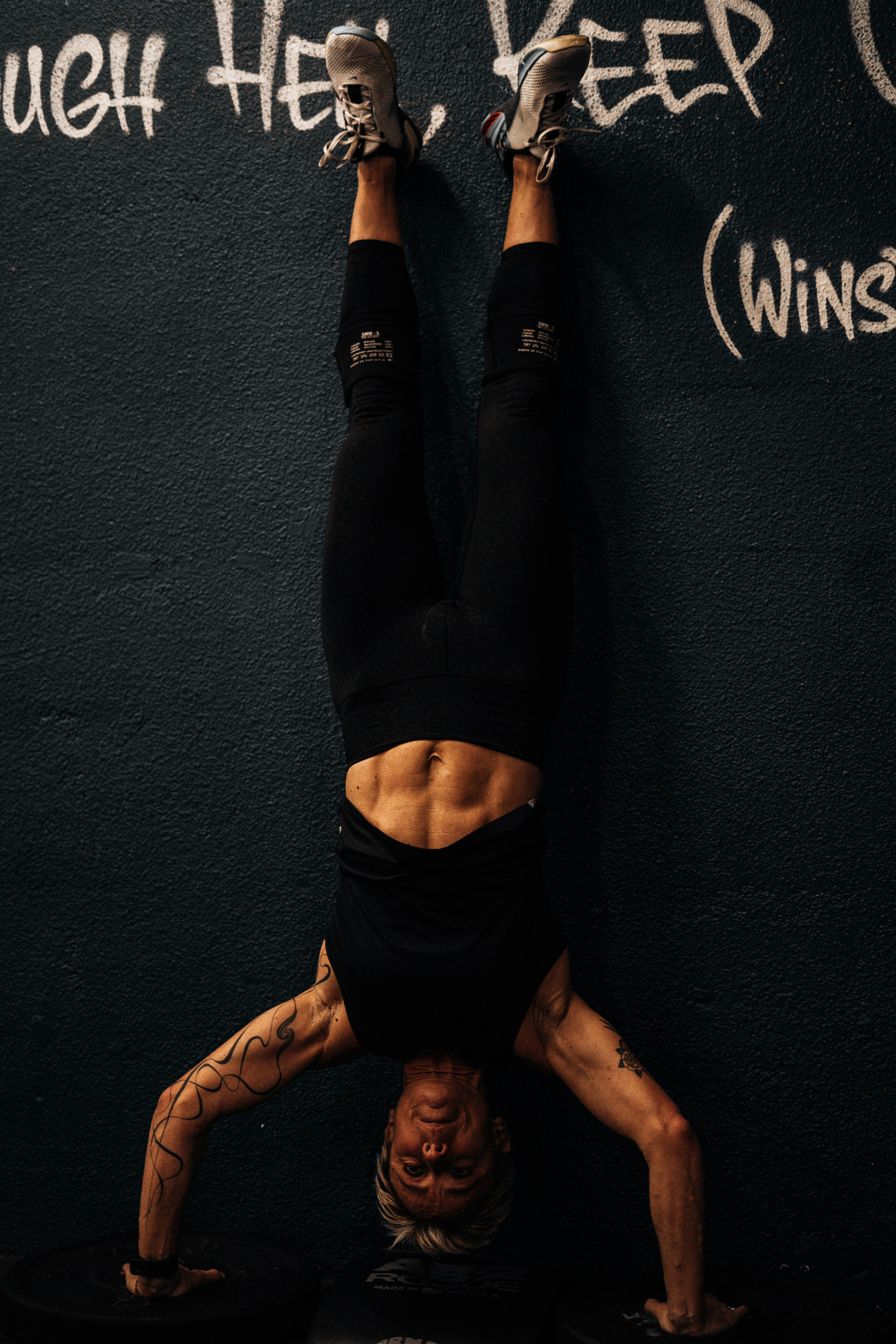 a man doing a handstand in front of a wall