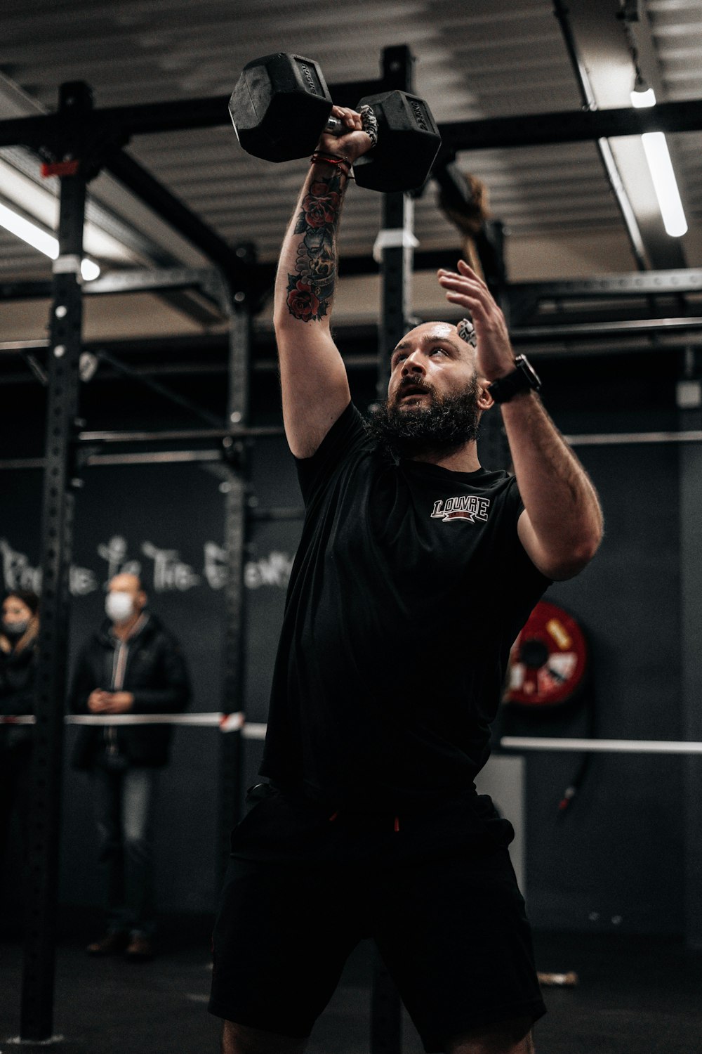 a man lifting a barbell in a gym