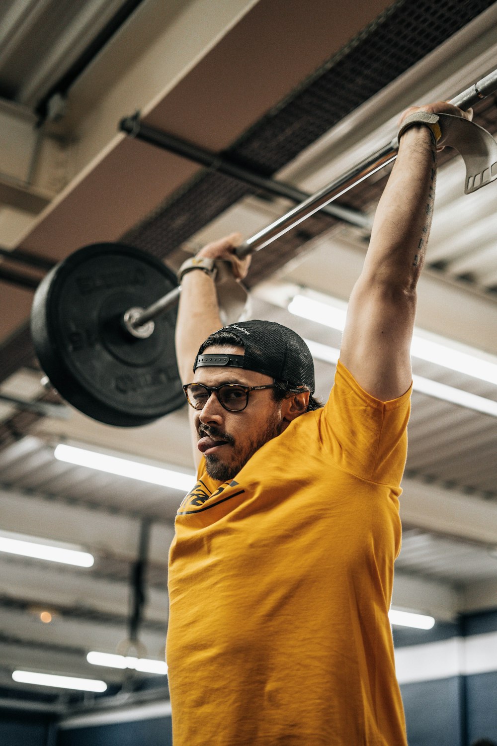 a man lifting a barbell in a gym