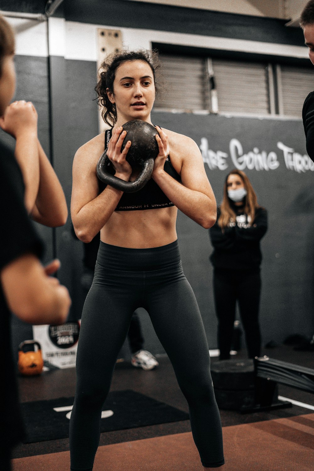 a woman holding a kettle in a gym