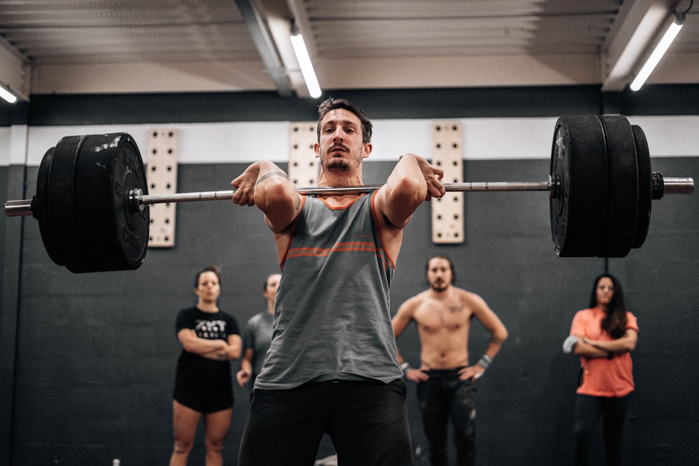 a man lifting a barbell in a gym