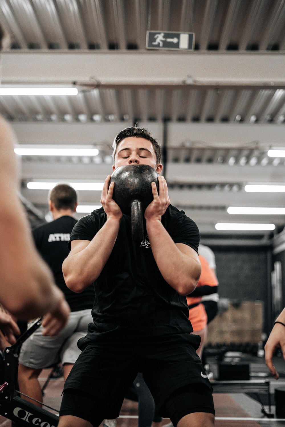 a man lifting a kettle in a gym