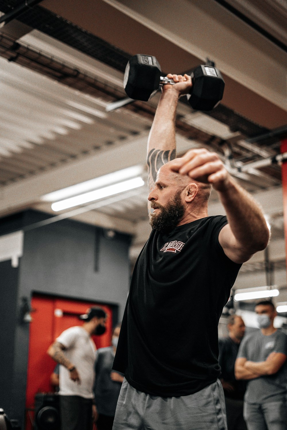 a man lifting a barbell in a gym