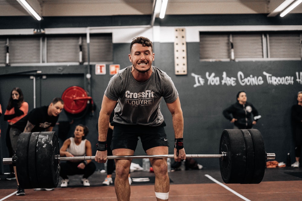 a man lifting a barbell in a gym