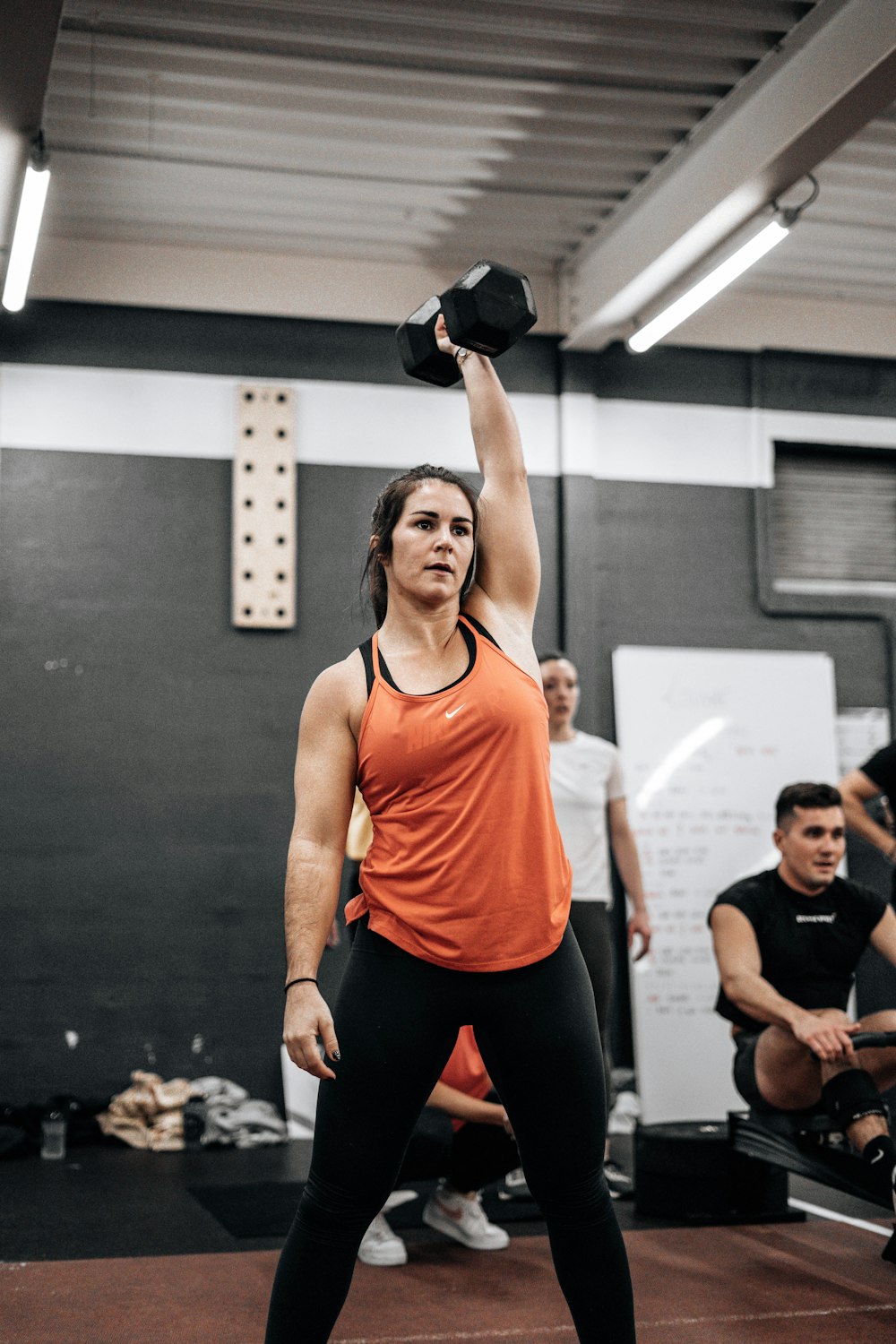 a woman lifting a kettle in a gym