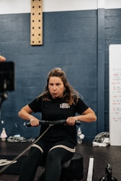 a woman on a stationary exercise bike in a gym